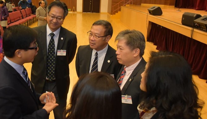 仁濟中小學校長把握機會，與基本法推廣督導委員會委員李浩然博士(左一)交流